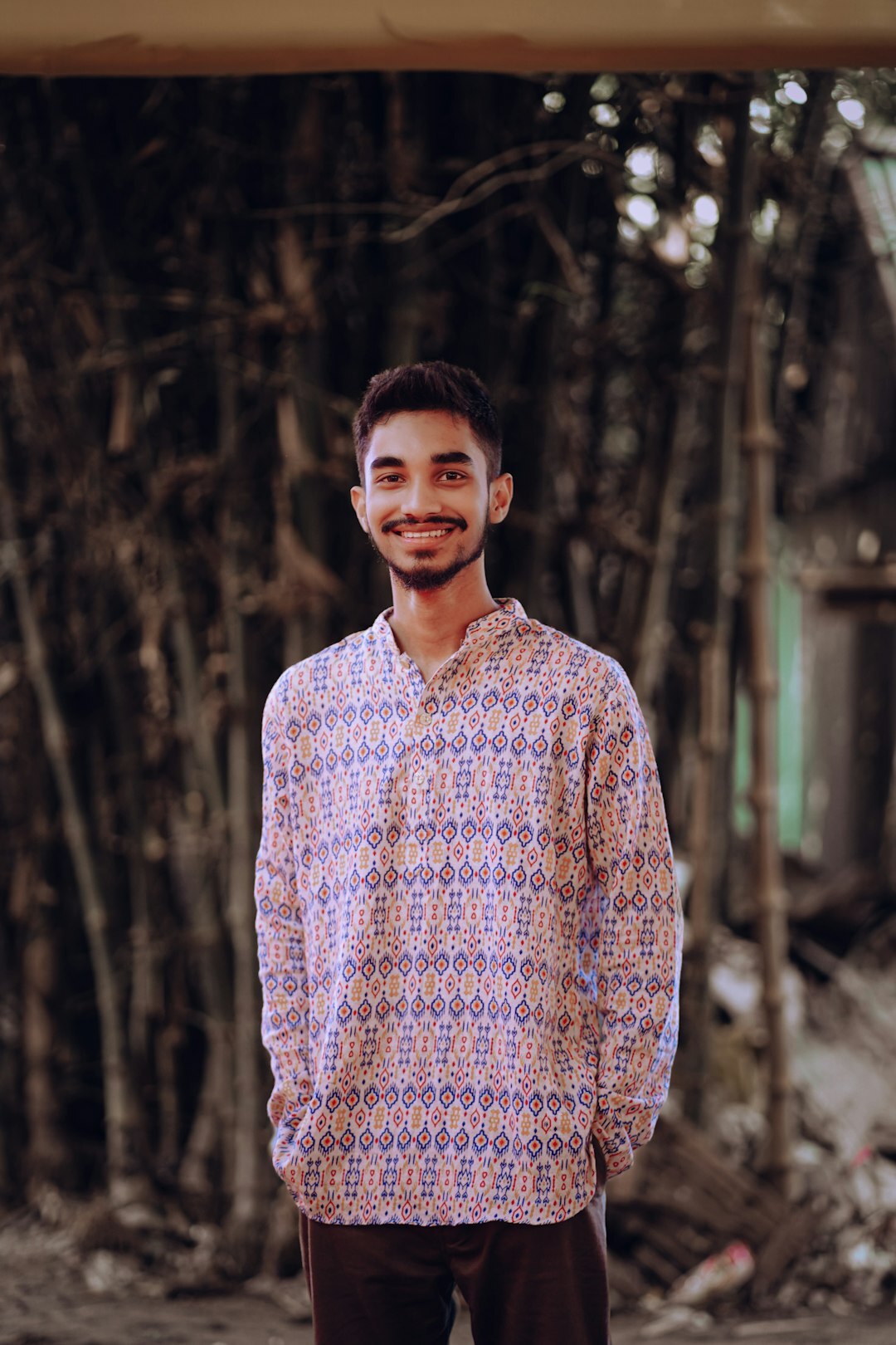 Young man in casual shirt smiling