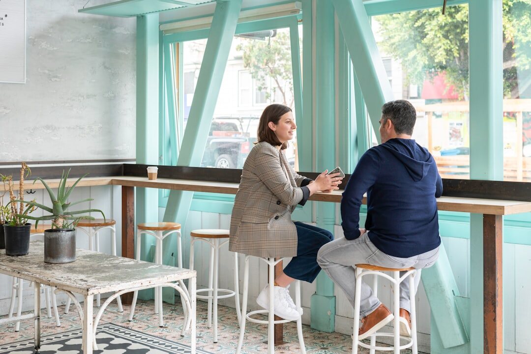 Two colleagues discussing during a business meeting
